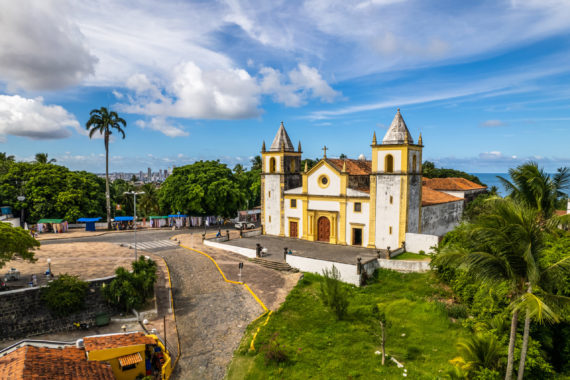 Olinda, Pernambuco, Brazil, circa April 2022: Aerial view of the city of Olinda in Alto da Sé with church, houses, sea and movement of people.
